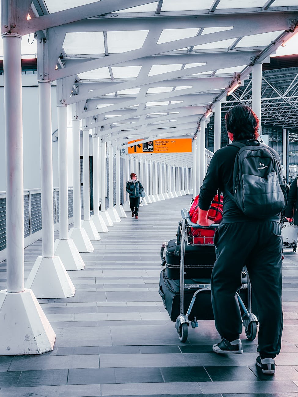 travelers at dortmund airport terminal walkway