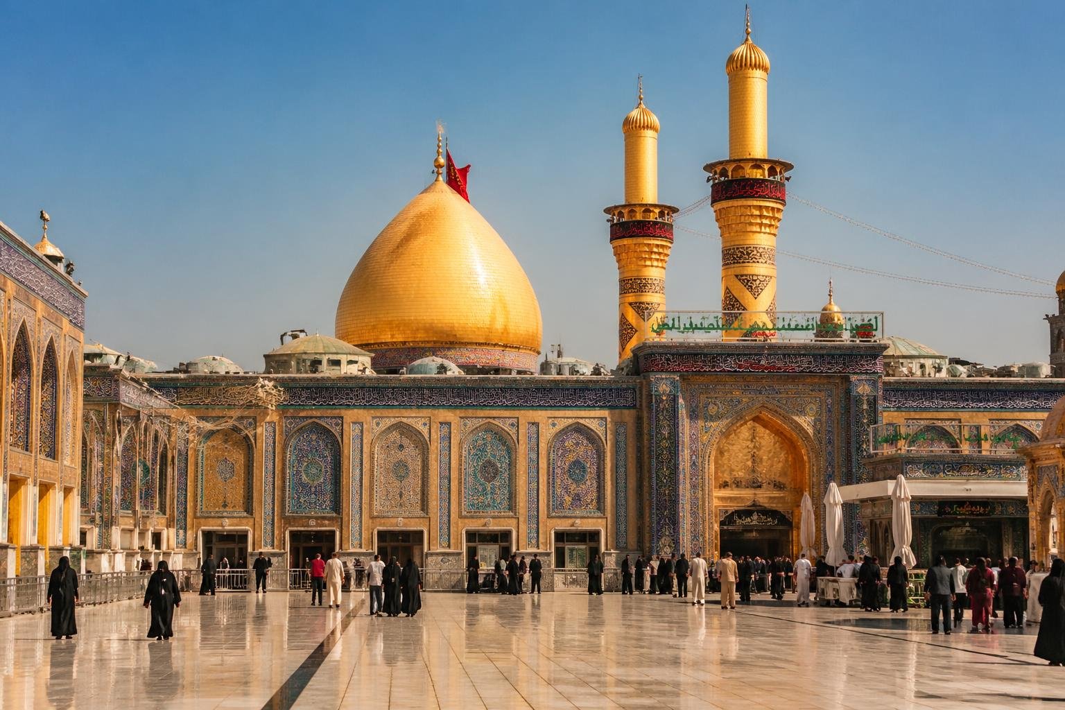 The Holy Shrine of Imam Hussain in Karbala with its golden dome, tall minarets, and a spacious courtyard under a clear sky.